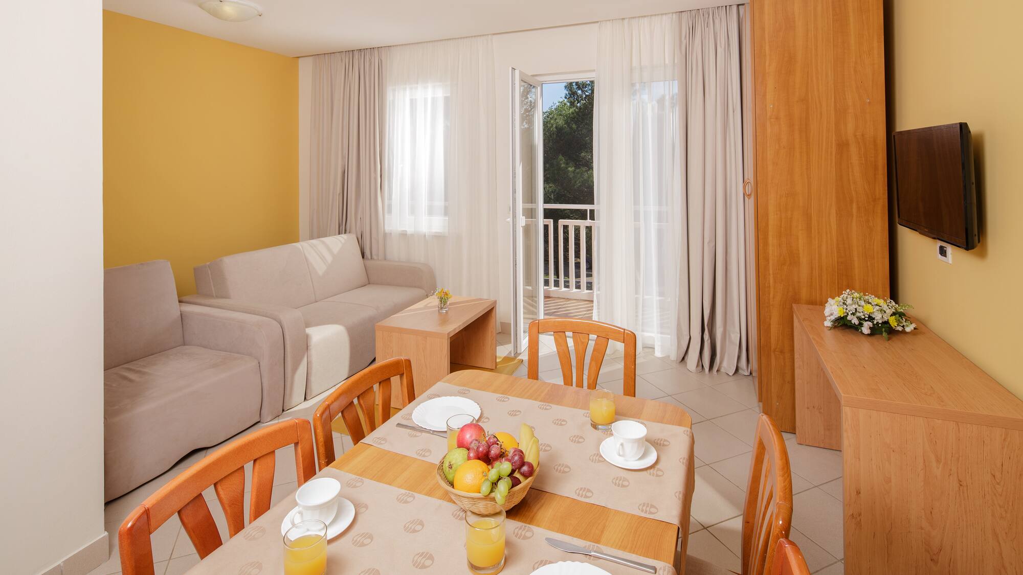 a room with a table and chairs and a couch