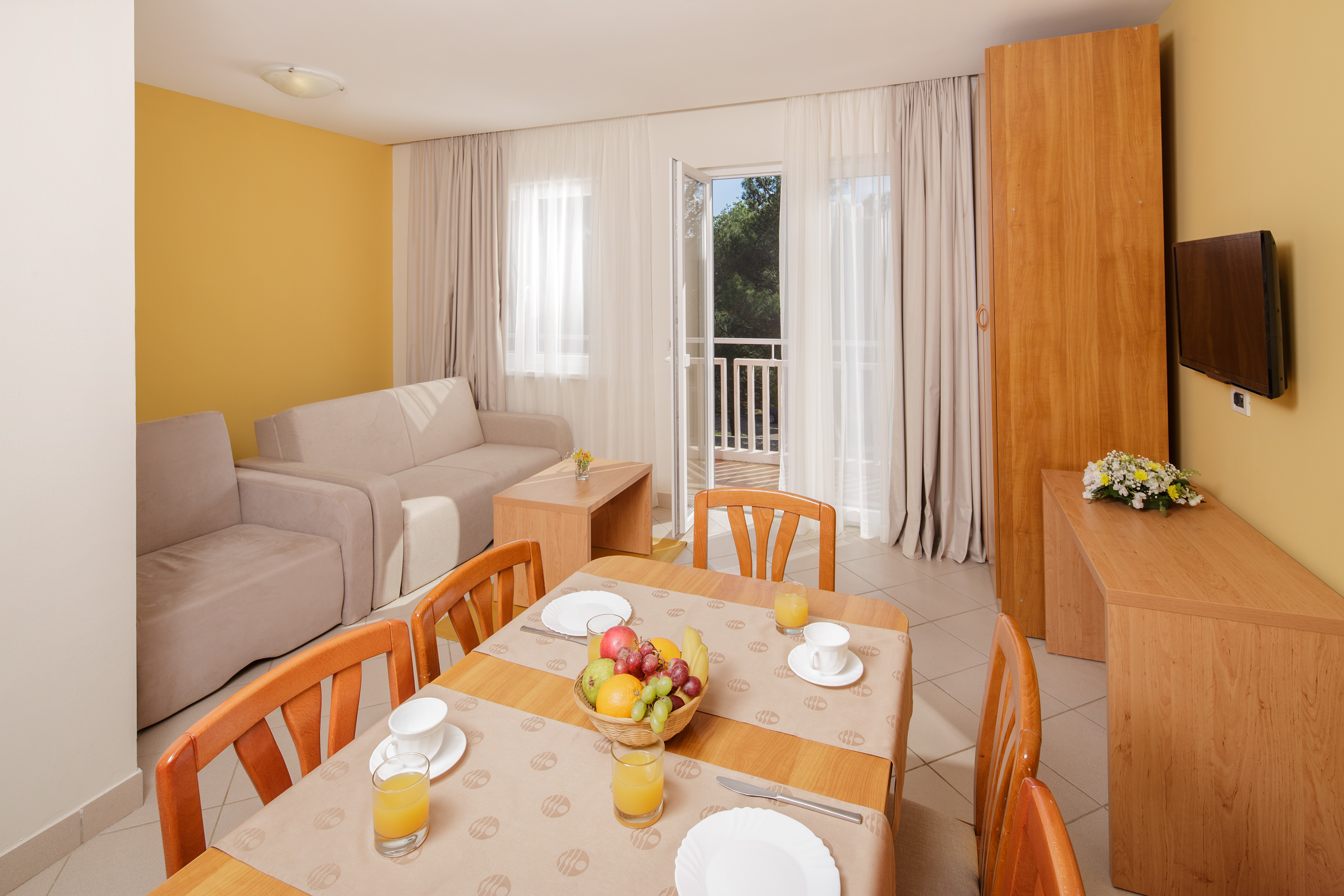 a room with a table and chairs and a couch