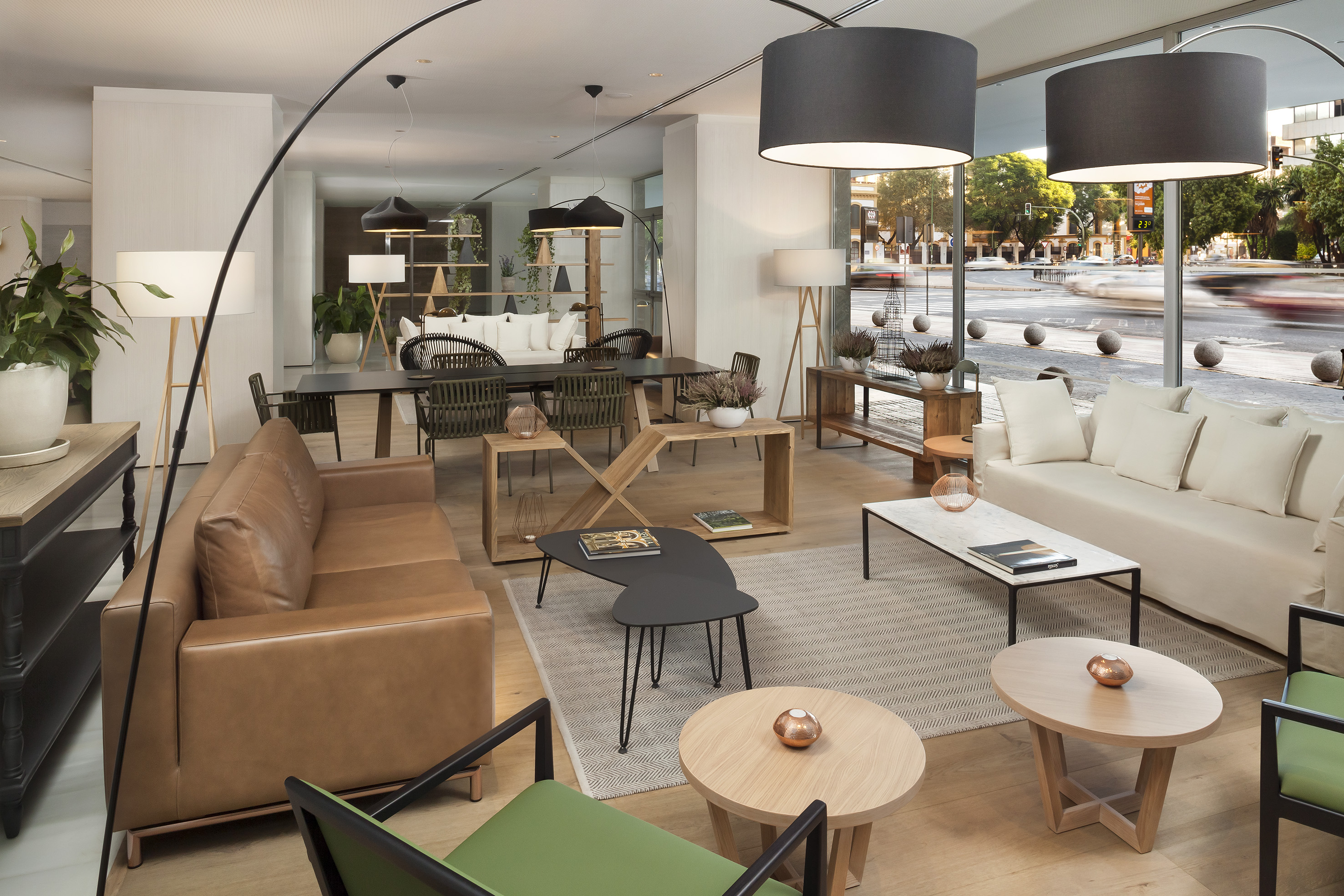 Modern lounge, brown leather sofa, white couch, coffee tables, city view.