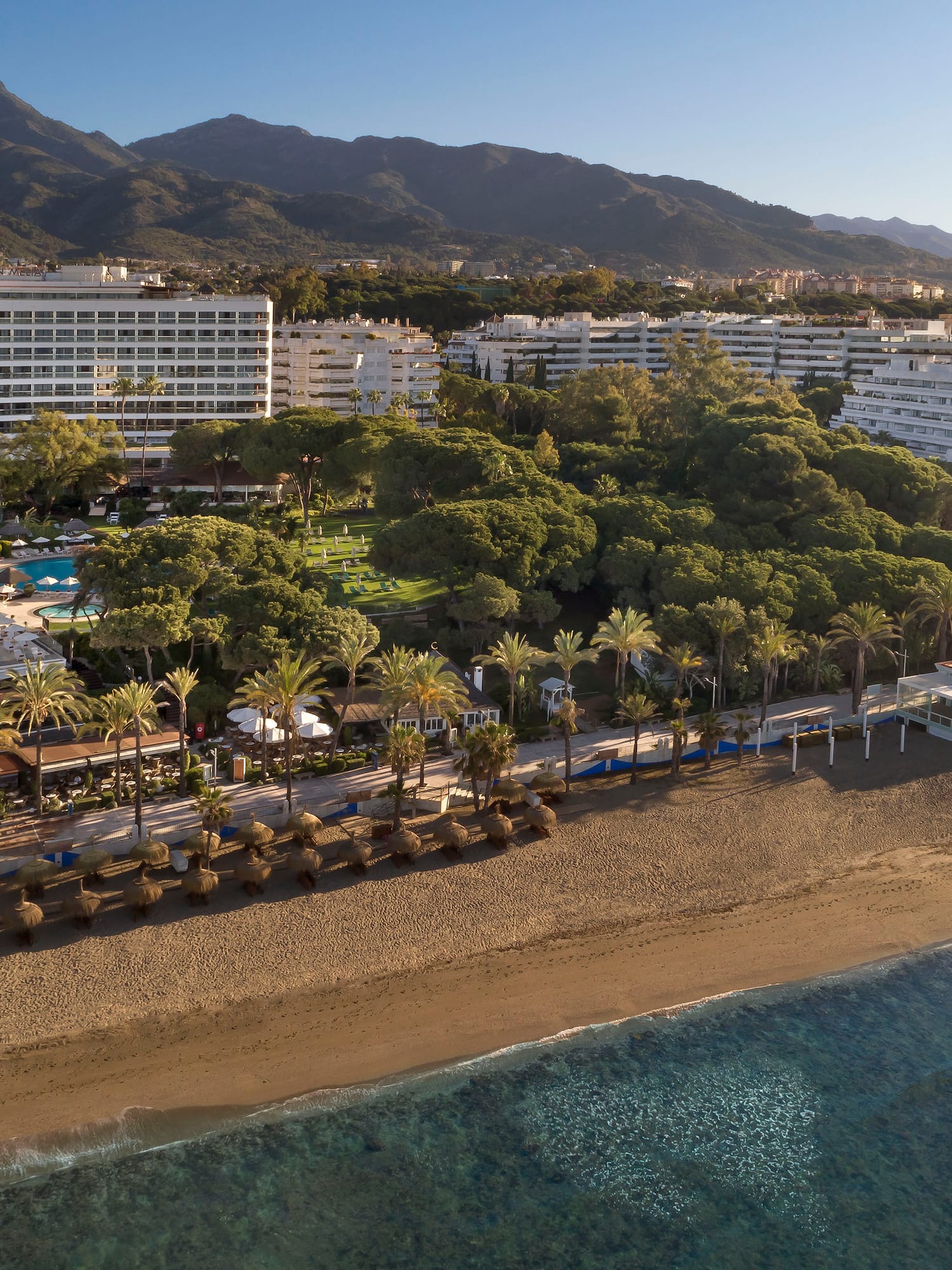 a beach with a body of water and buildings