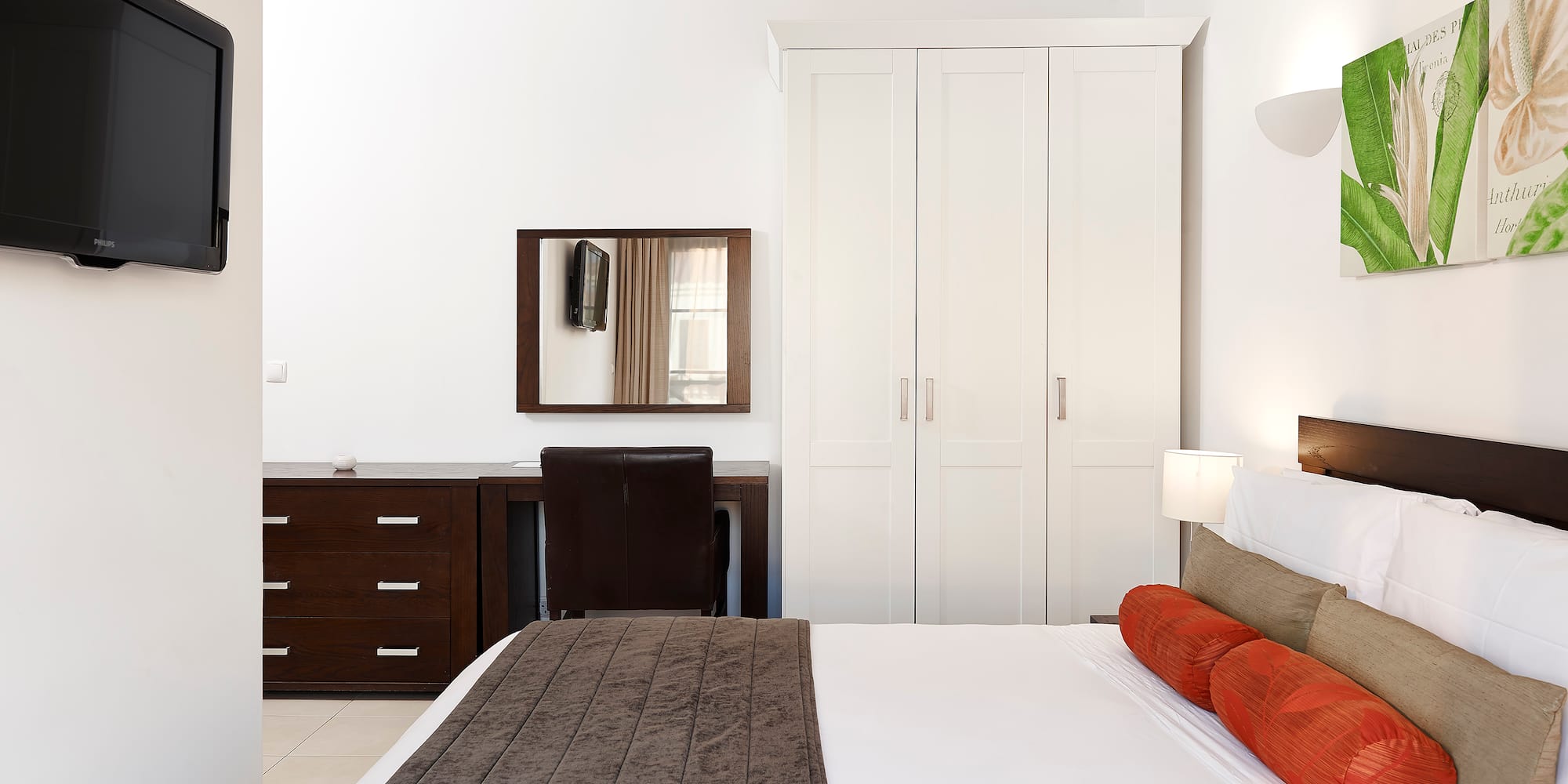 a bedroom with a bed and a mirror