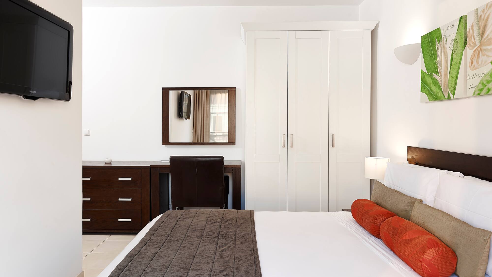 a bedroom with a bed and a mirror