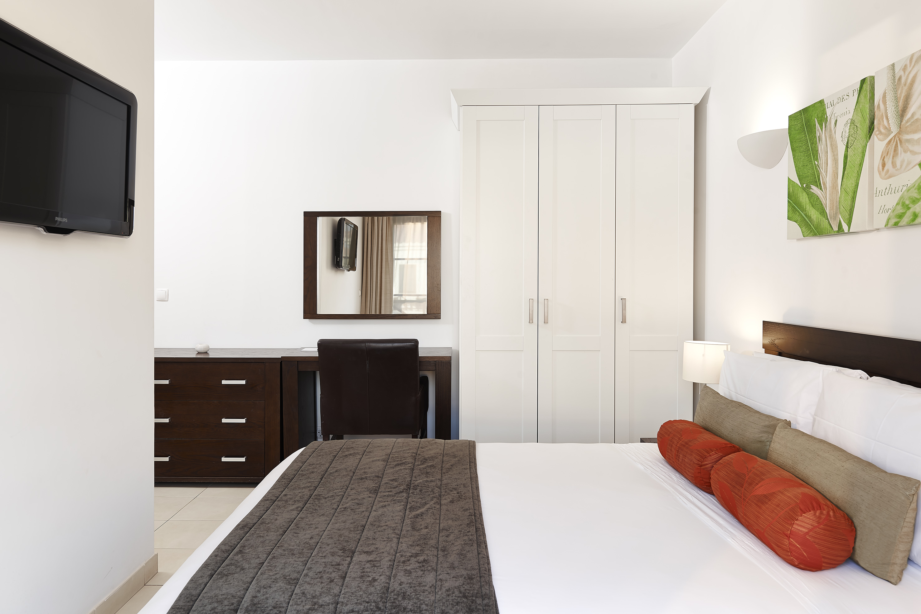 a bedroom with a bed and a mirror