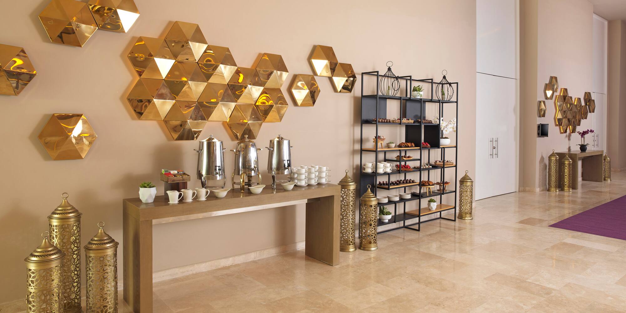 a room with a table with coffee cups and shelves