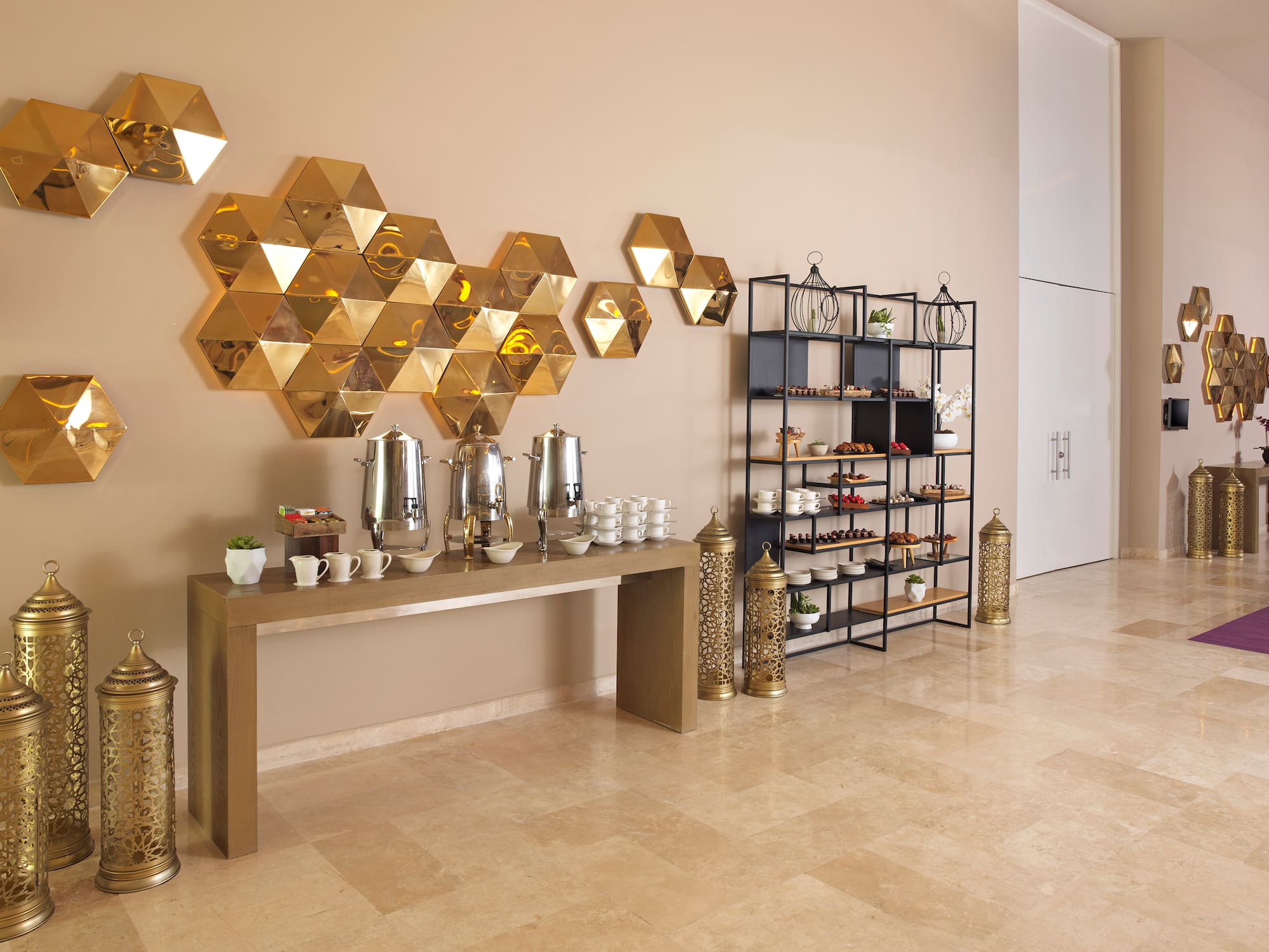 a room with a table with coffee cups and shelves