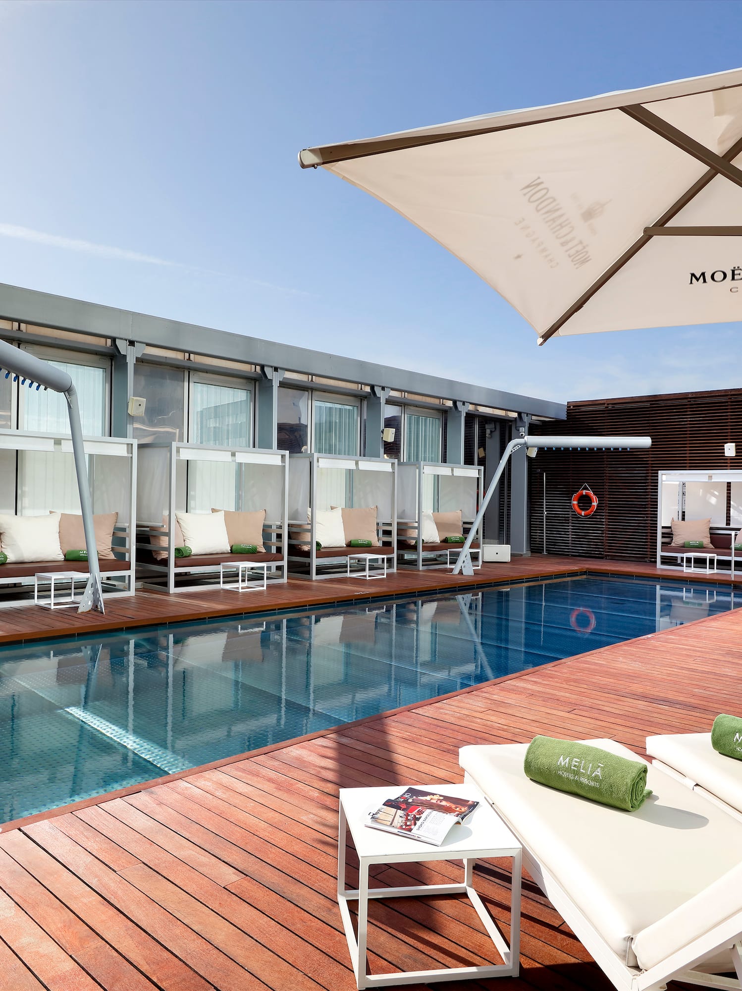 a pool with lounge chairs and umbrellas