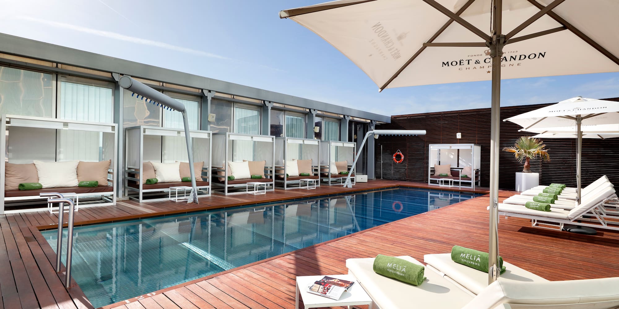 a pool with lounge chairs and umbrellas