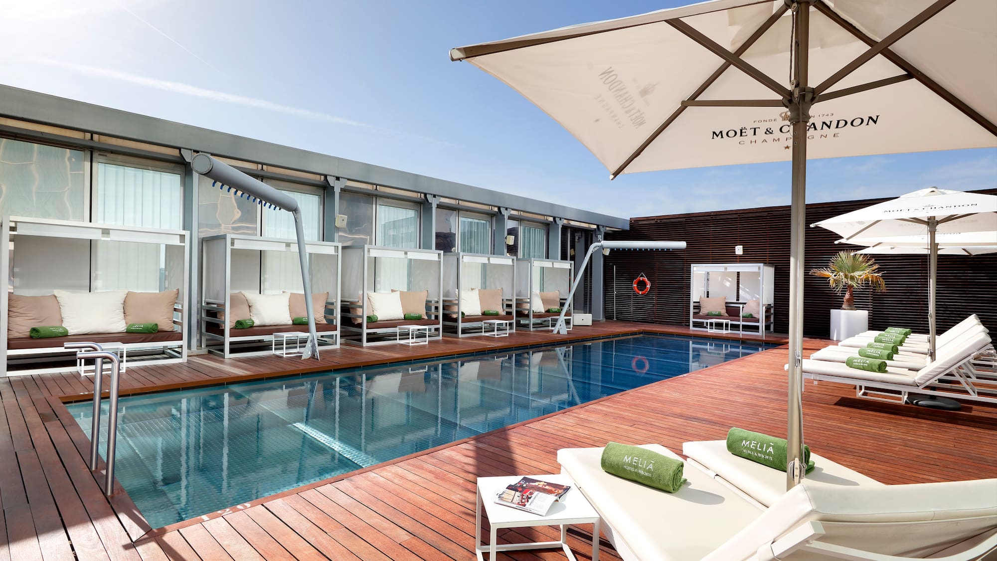 a pool with lounge chairs and umbrellas