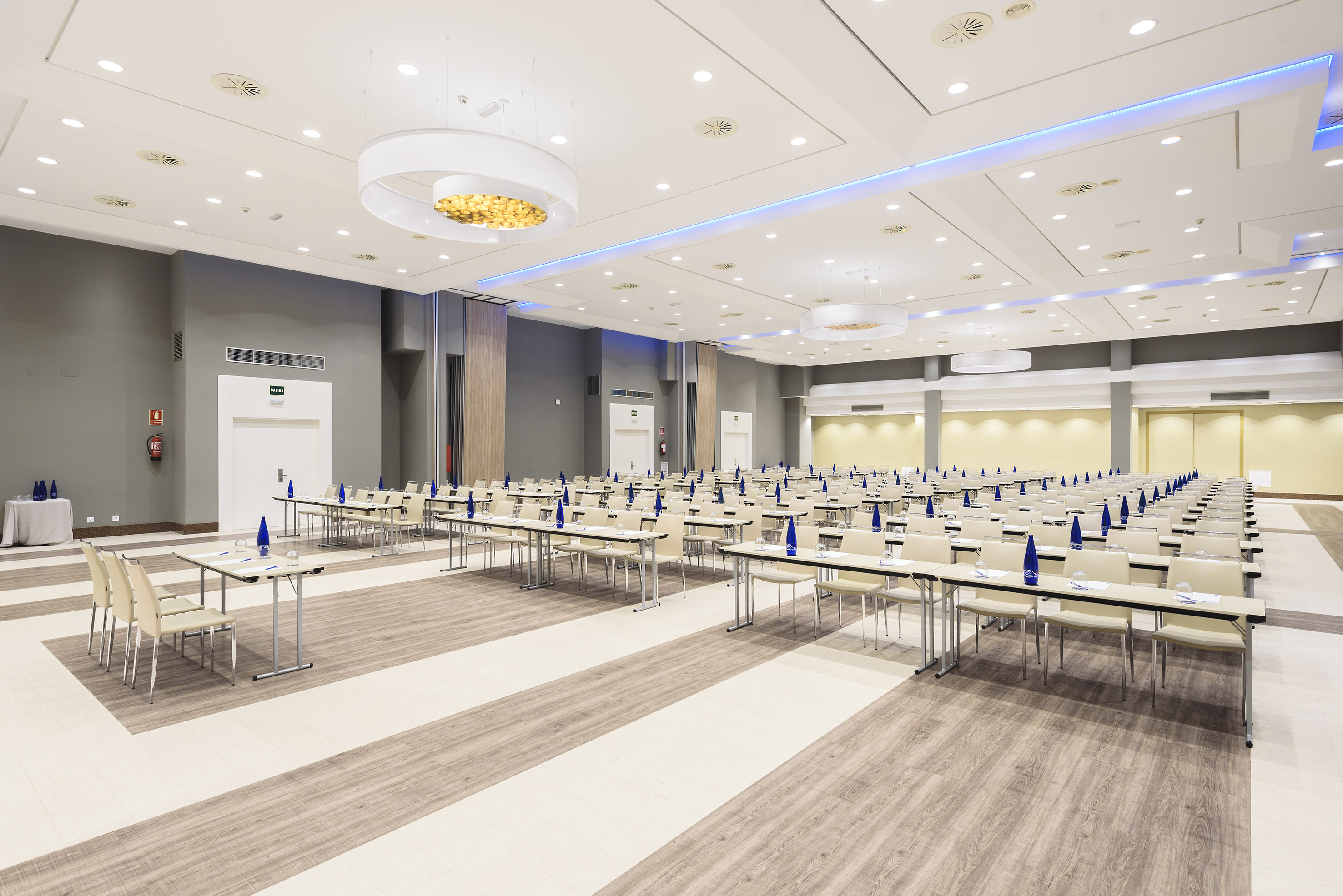 Spacious meeting room with modern tables and chairs ready for a conference.