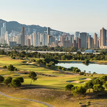 a golf course with a city in the background