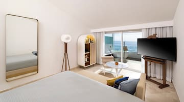 a room with a bed and a television