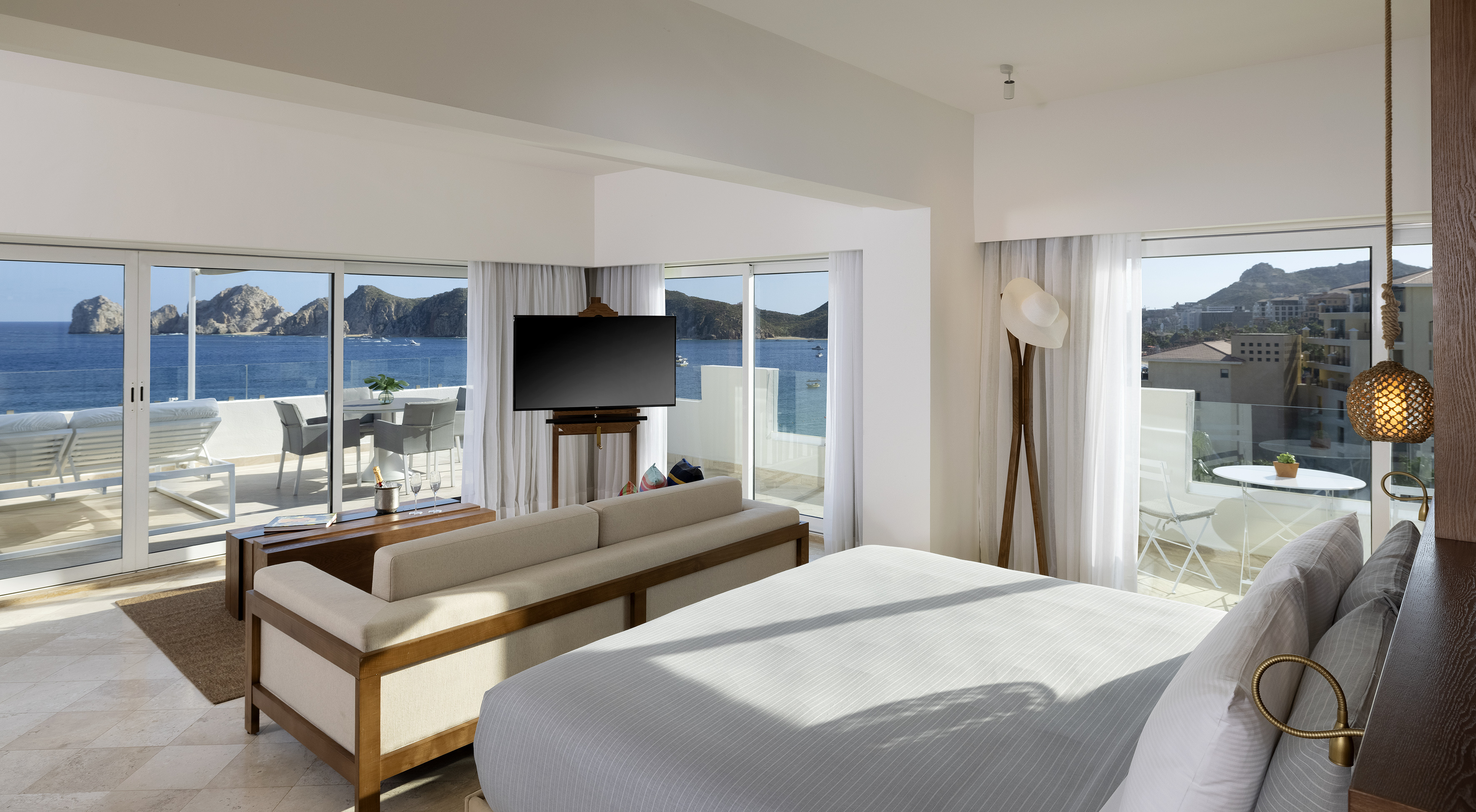 Cabo San Lucas luxury suite with ocean view balcony and coastal scenery.