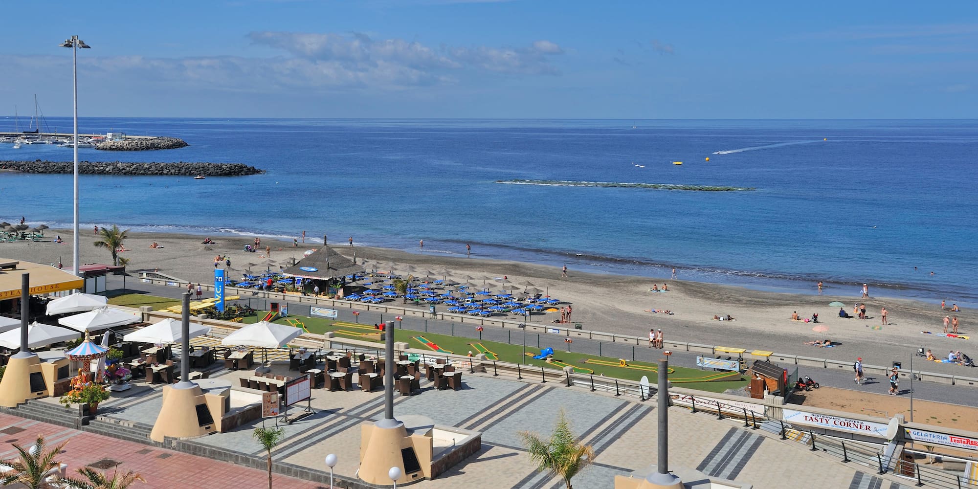 a beach with a lot of people and a body of water