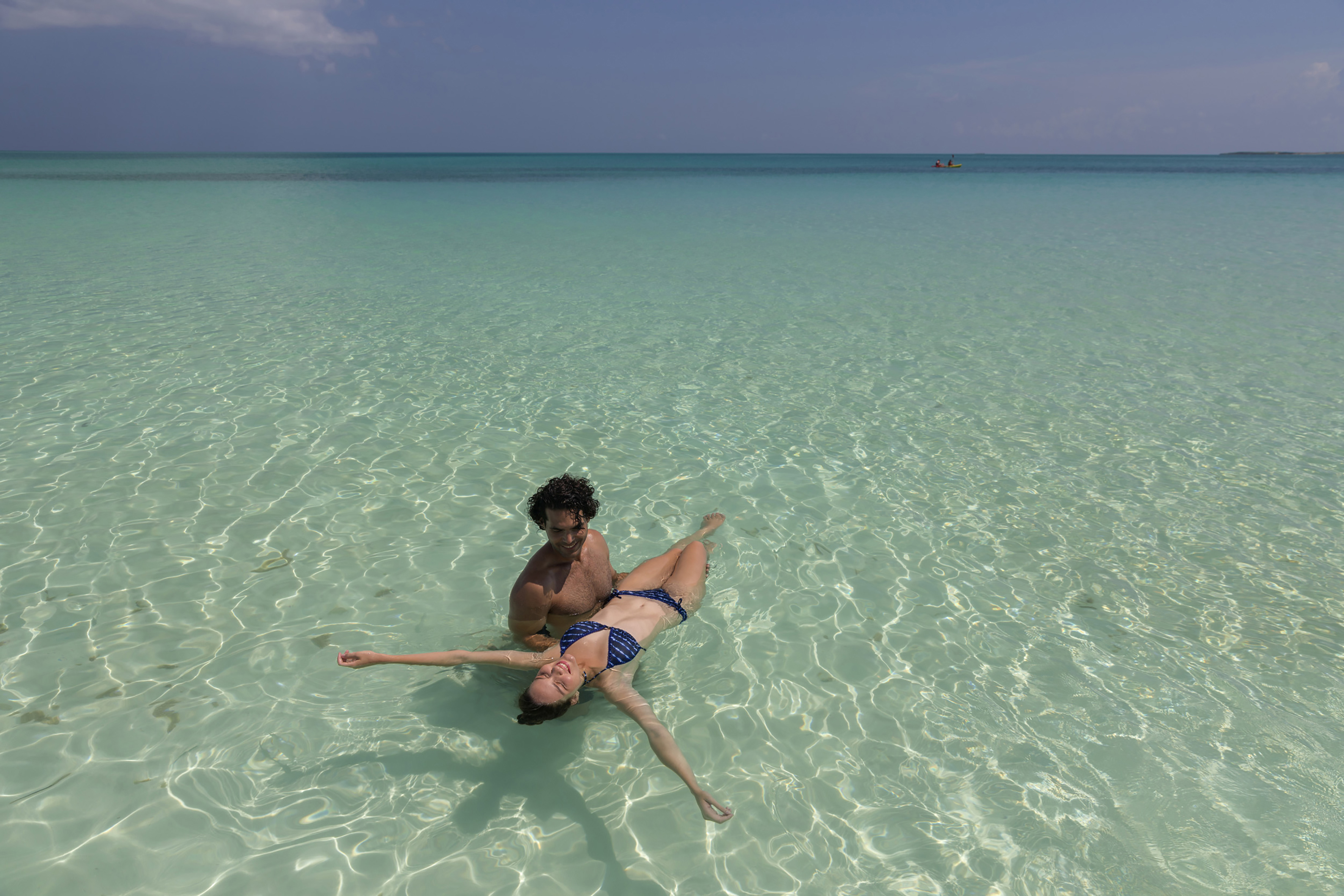 a man and woman in a garment in the water