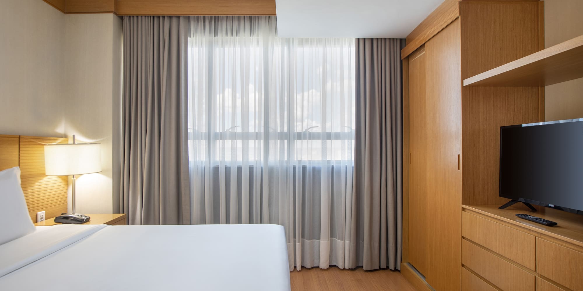 a bedroom with a bed and a cabinet