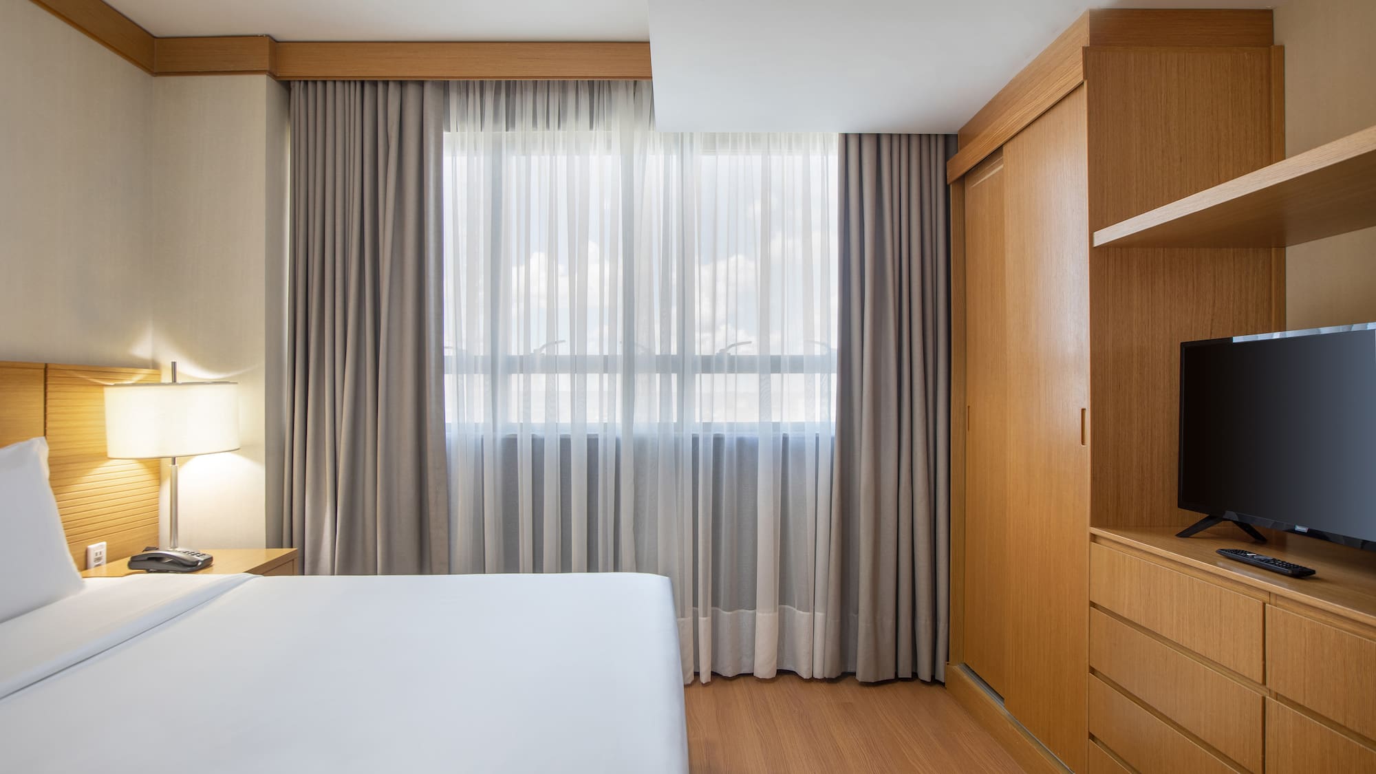 a bedroom with a bed and a cabinet