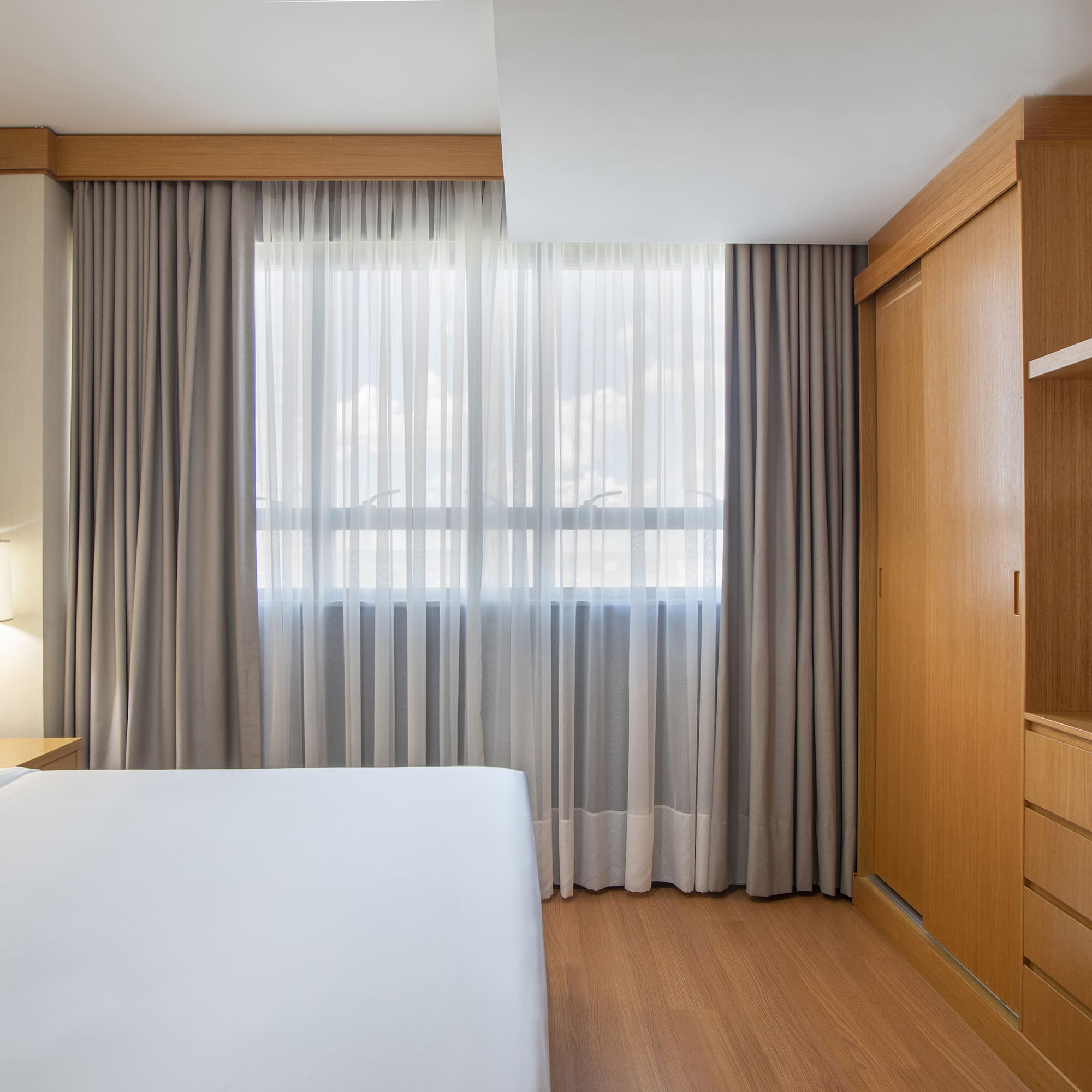 a bedroom with a bed and a cabinet