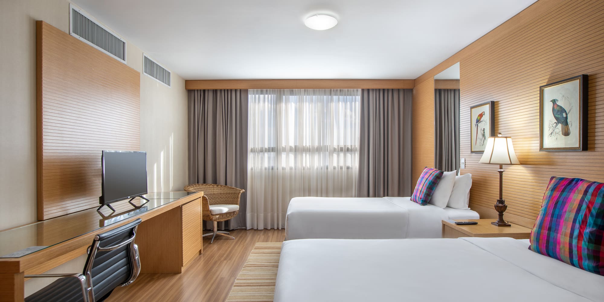 a room with two beds and a desk