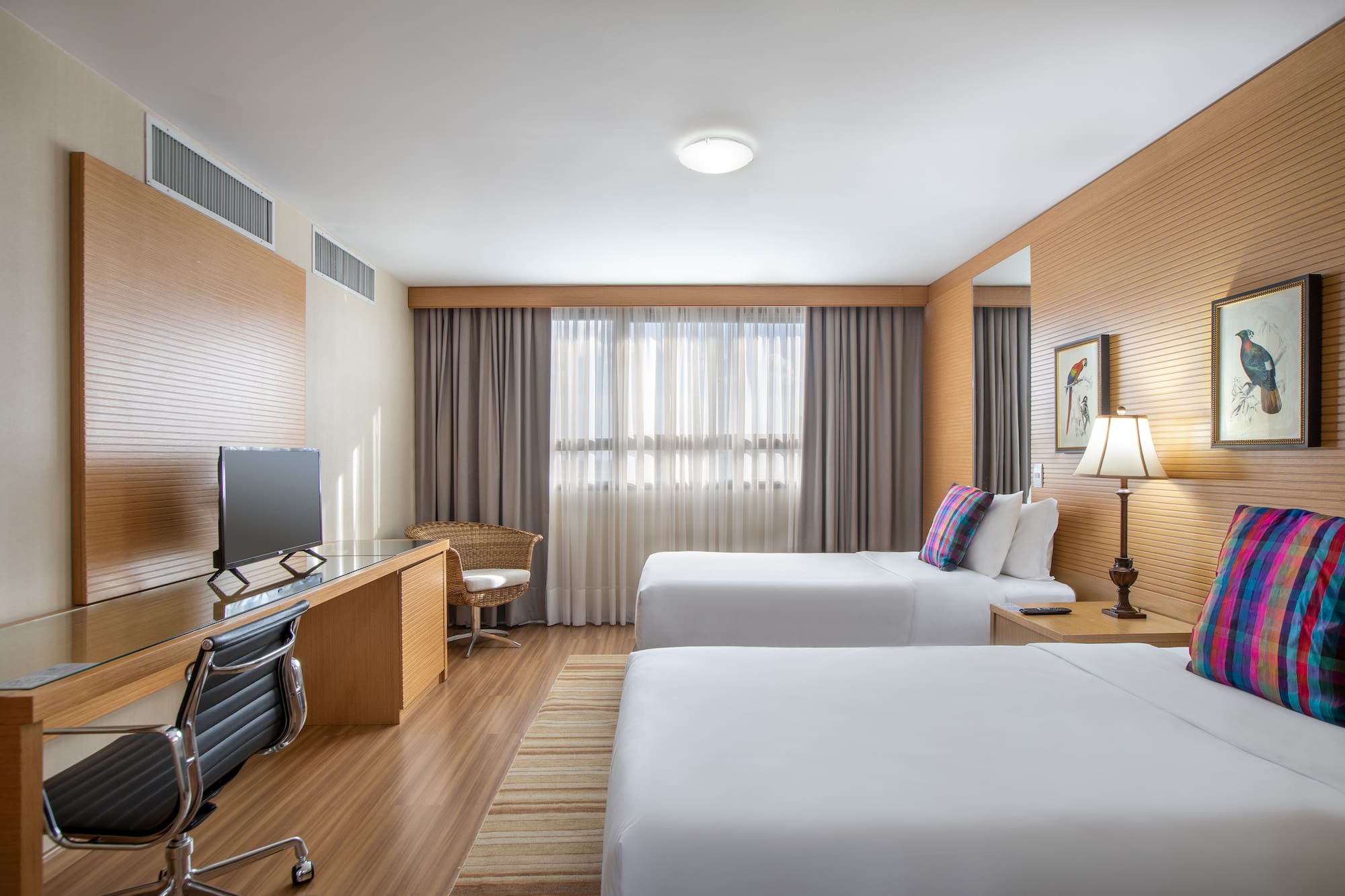 a room with two beds and a desk