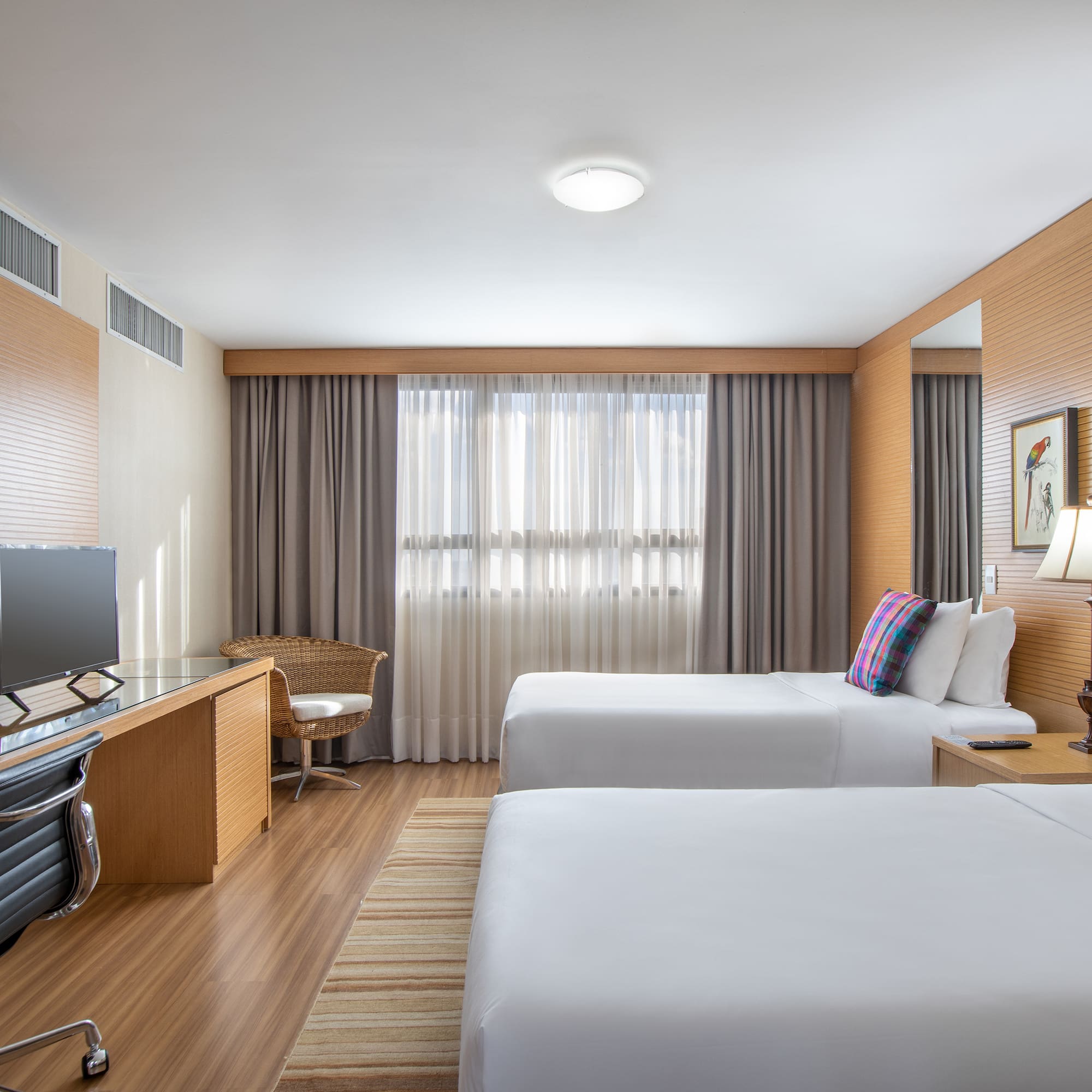 a room with two beds and a desk