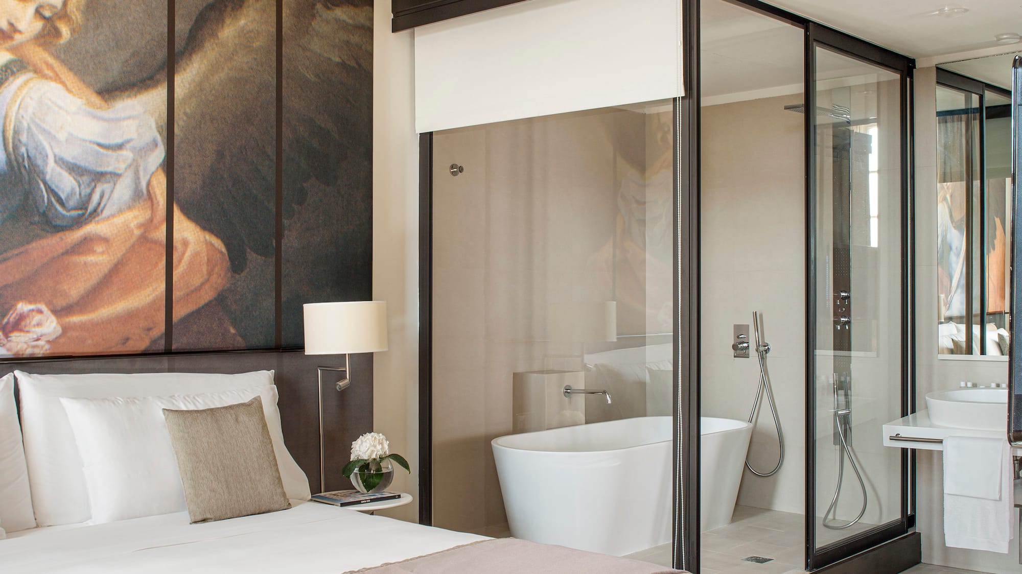 a bedroom with a large mirror and a large wall with a picture of an angel