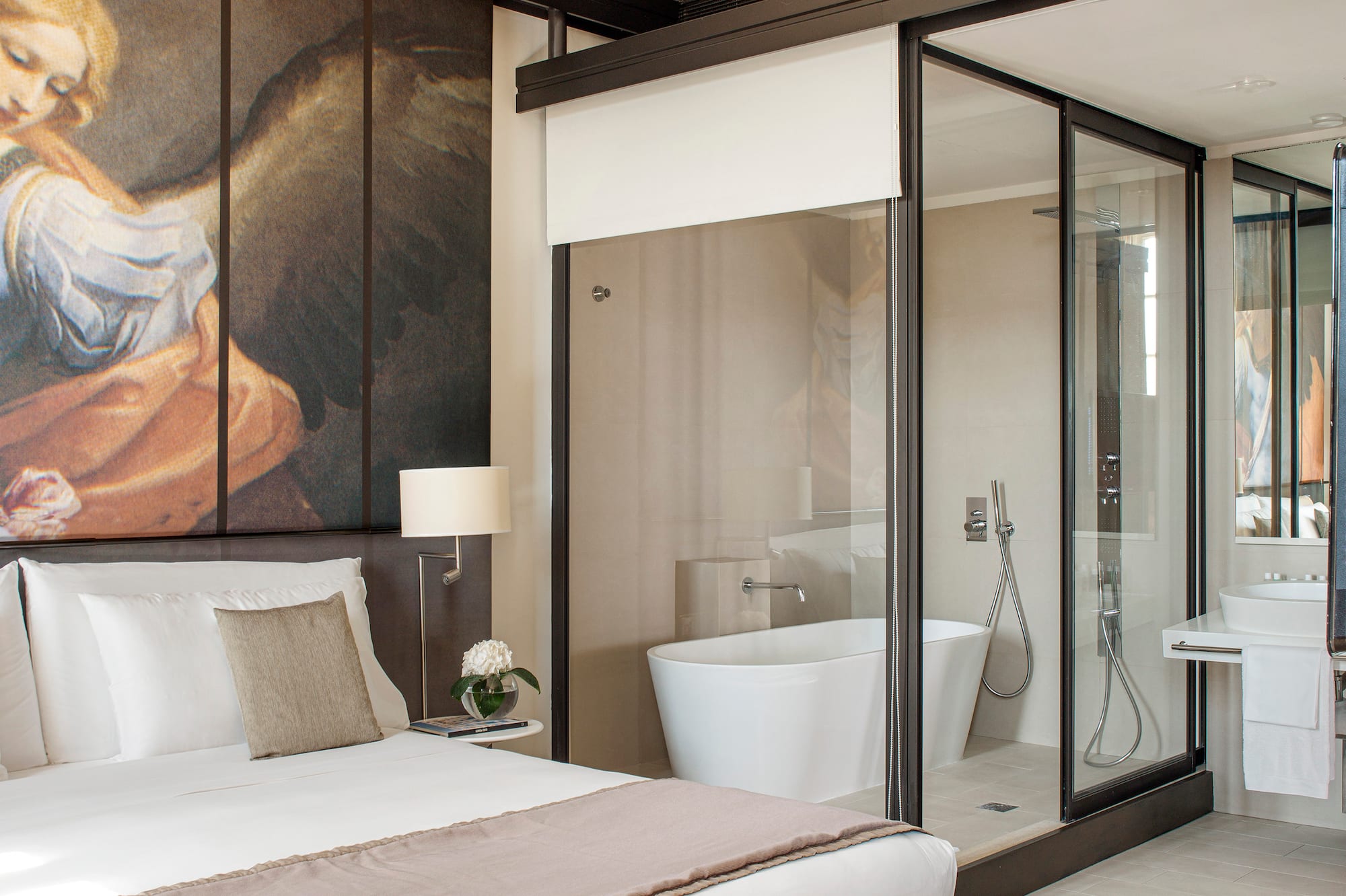a bedroom with a large mirror and a large wall with a picture of an angel