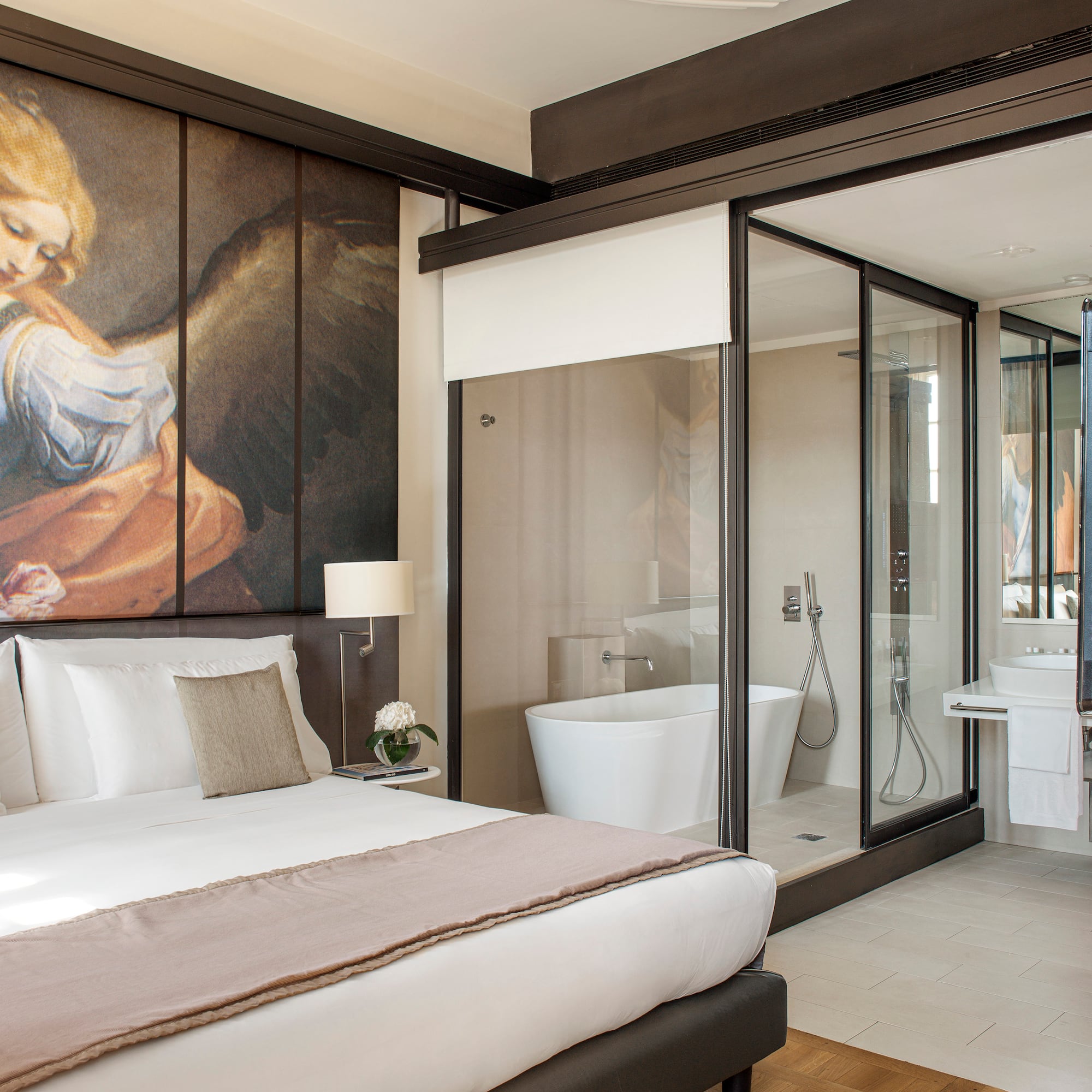 a bedroom with a large mirror and a large wall with a picture of an angel