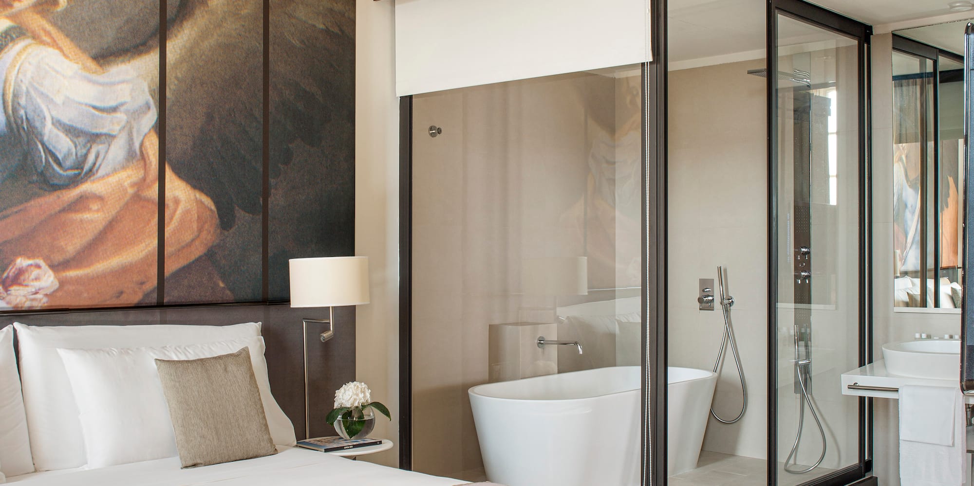 a bedroom with a large mirror and a large wall with a picture of an angel