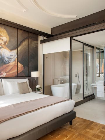 a bedroom with a large mirror and a large wall with a picture of an angel