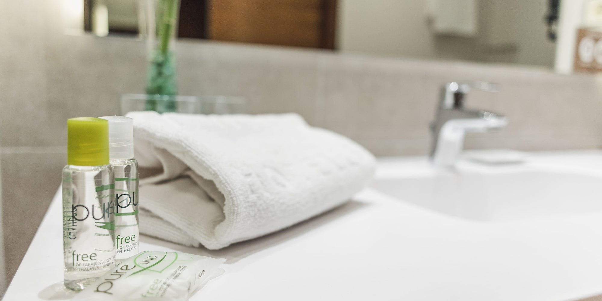 a white towel and small bottles on a counter