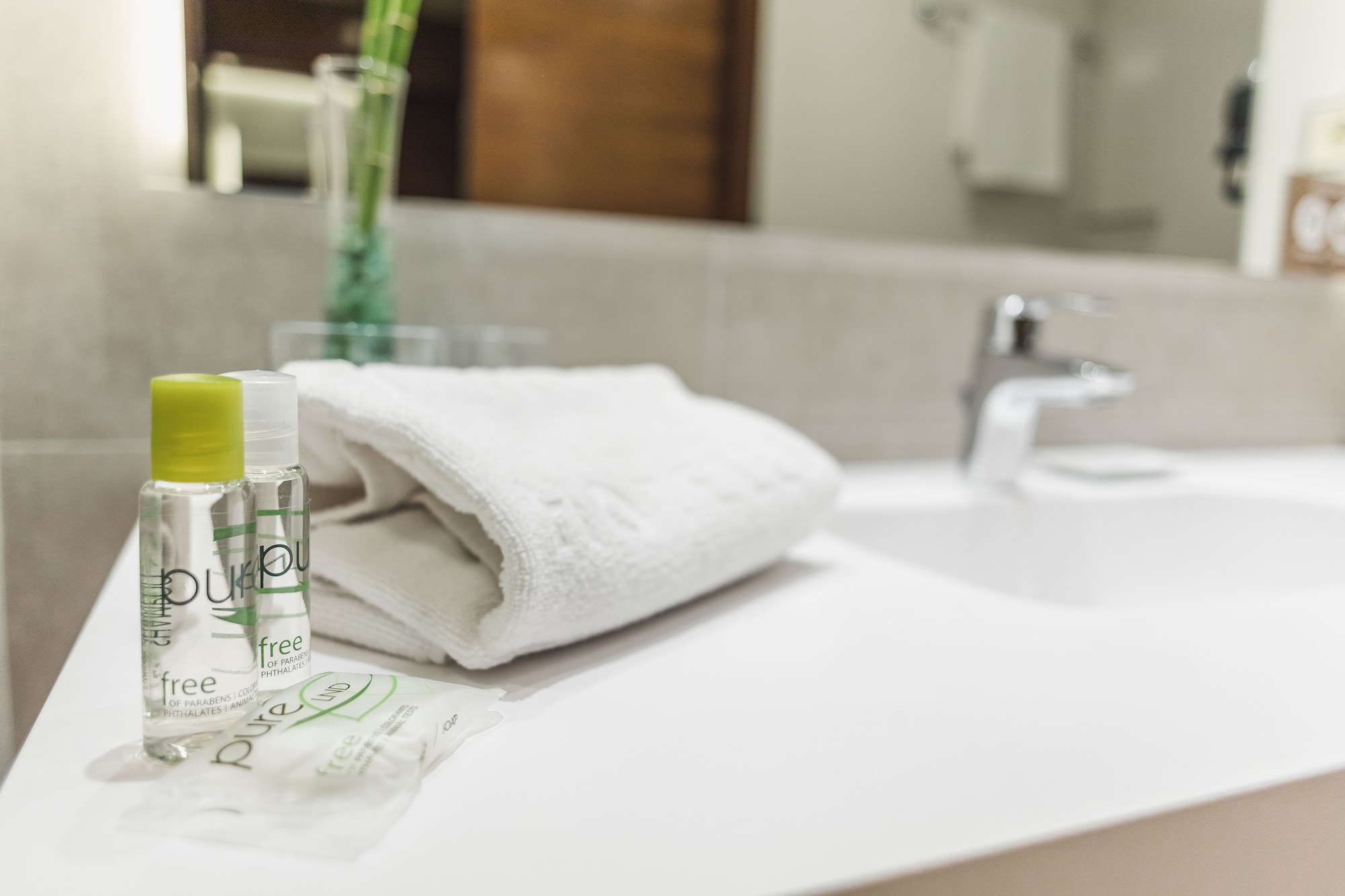 a white towel and small bottles on a counter