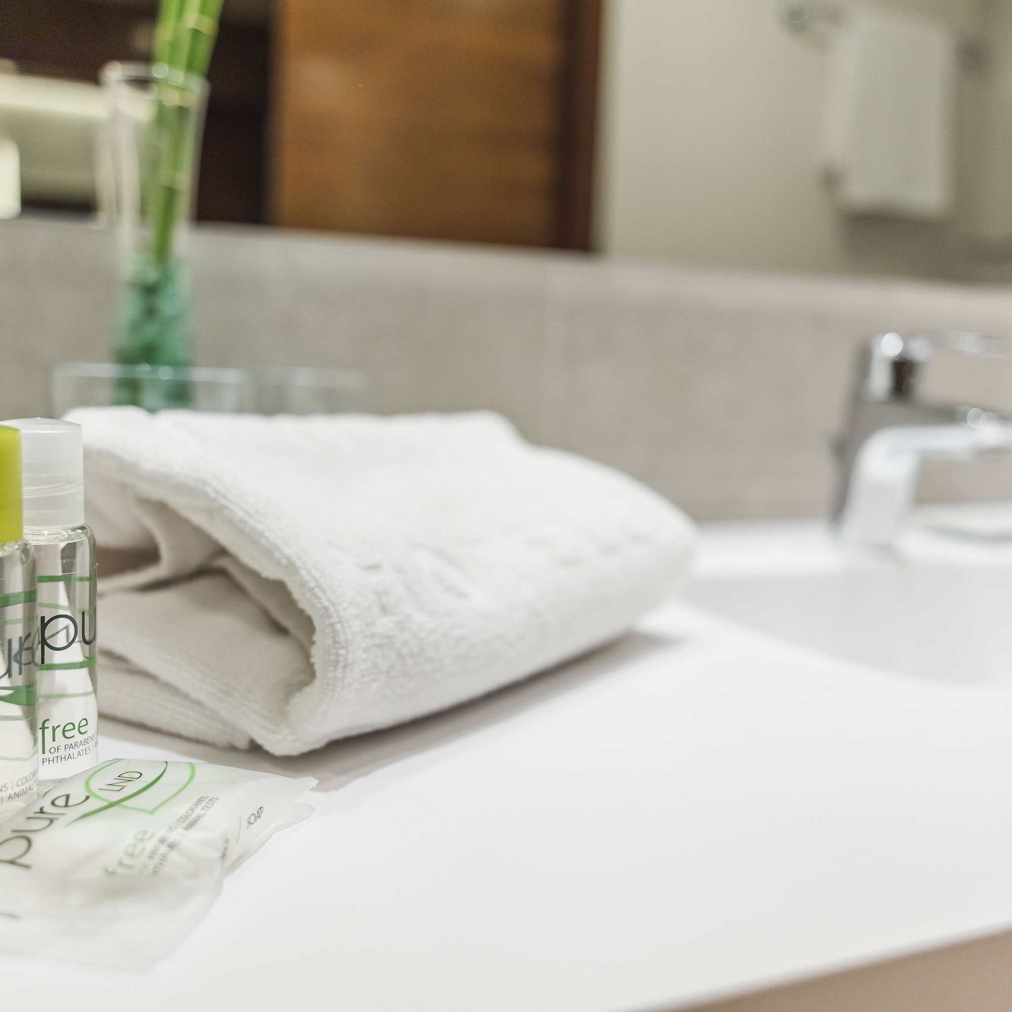 a white towel and small bottles on a counter
