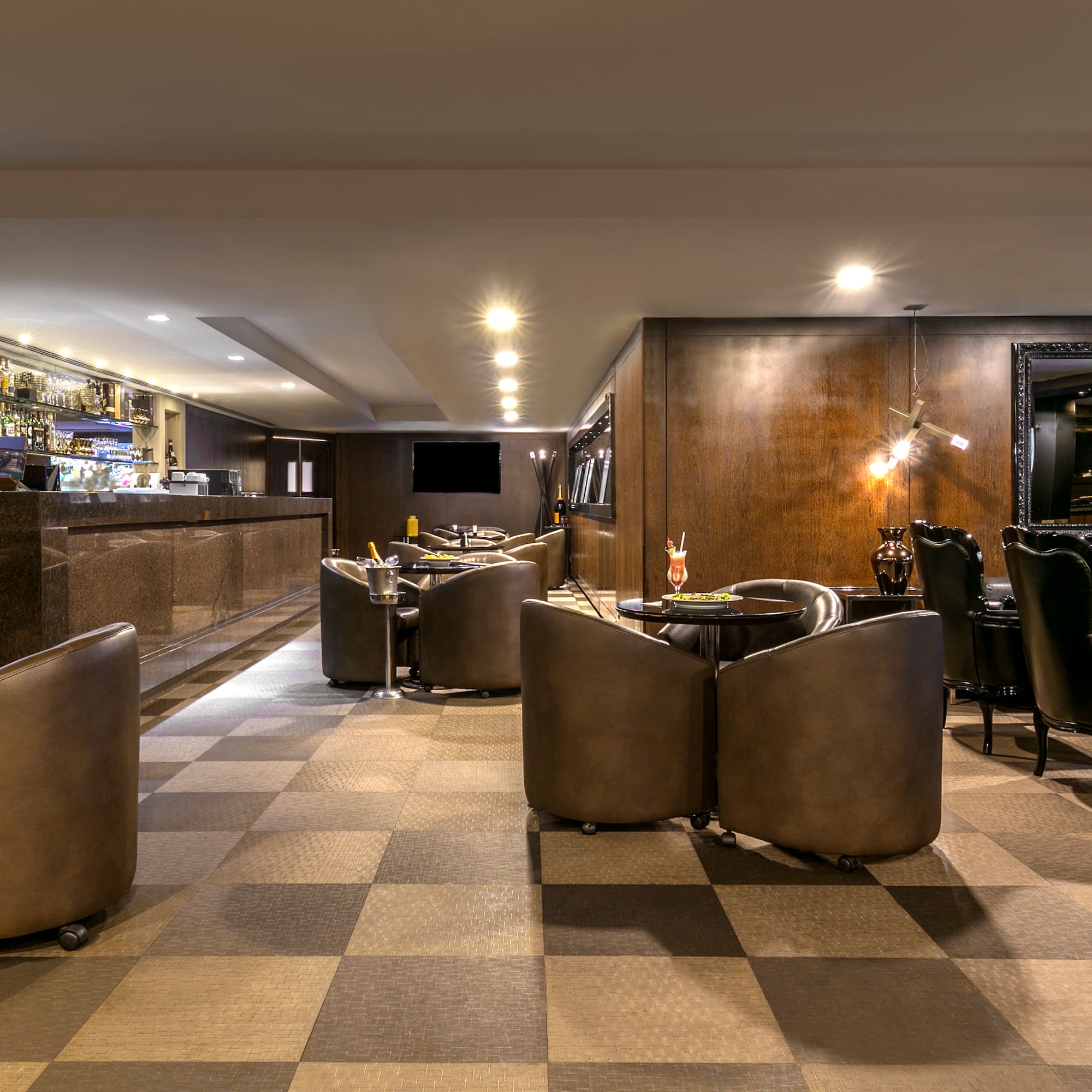a room with a checkered floor and a bar with tables and chairs