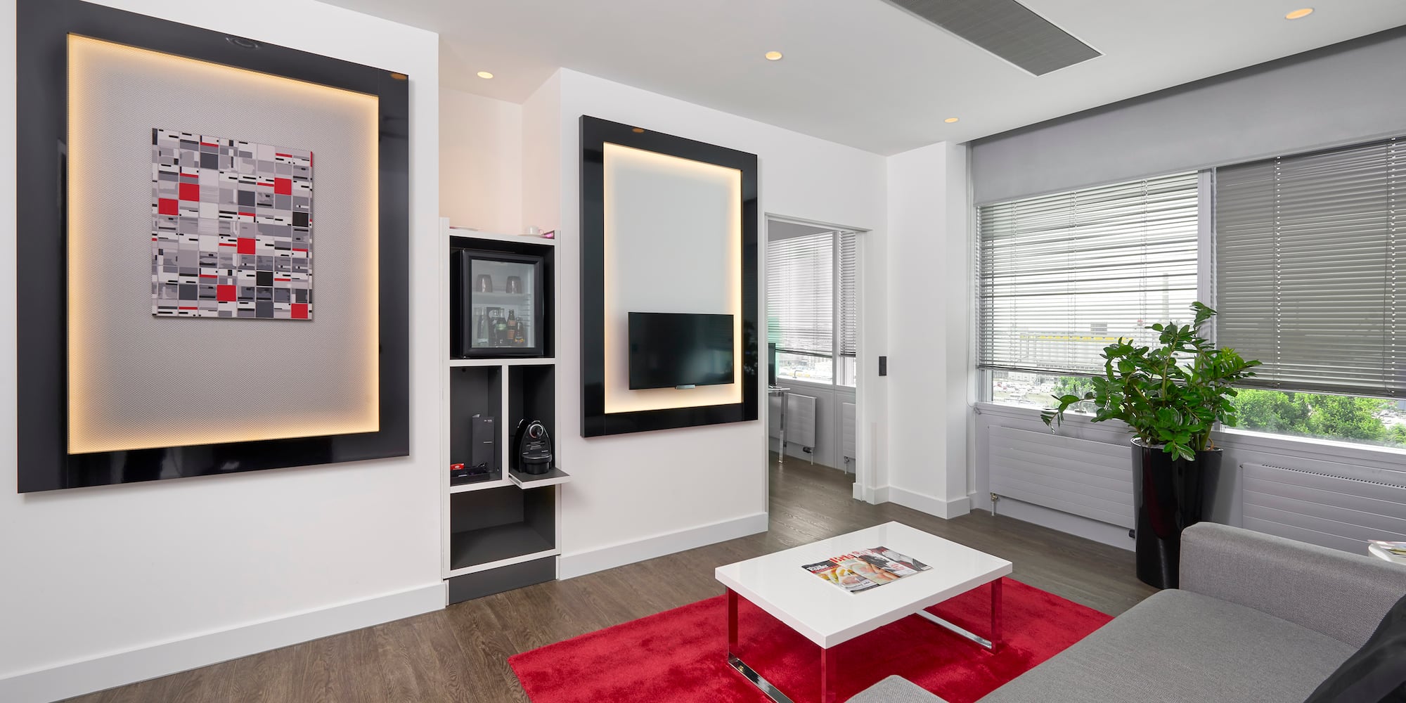 a living room with a red rug and a couch