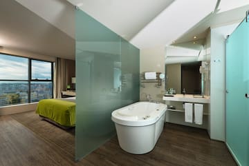 a bathroom with a bathtub and a mirror