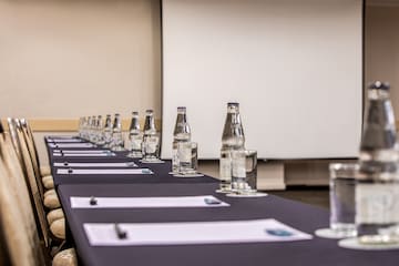 a long table with water bottles and glasses on it