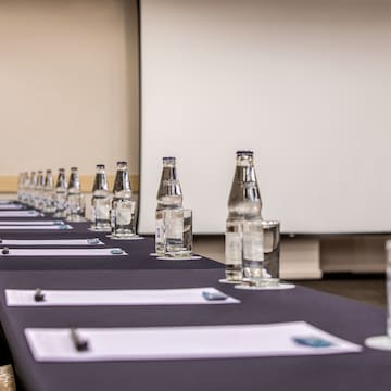 a long table with water bottles and glasses on it