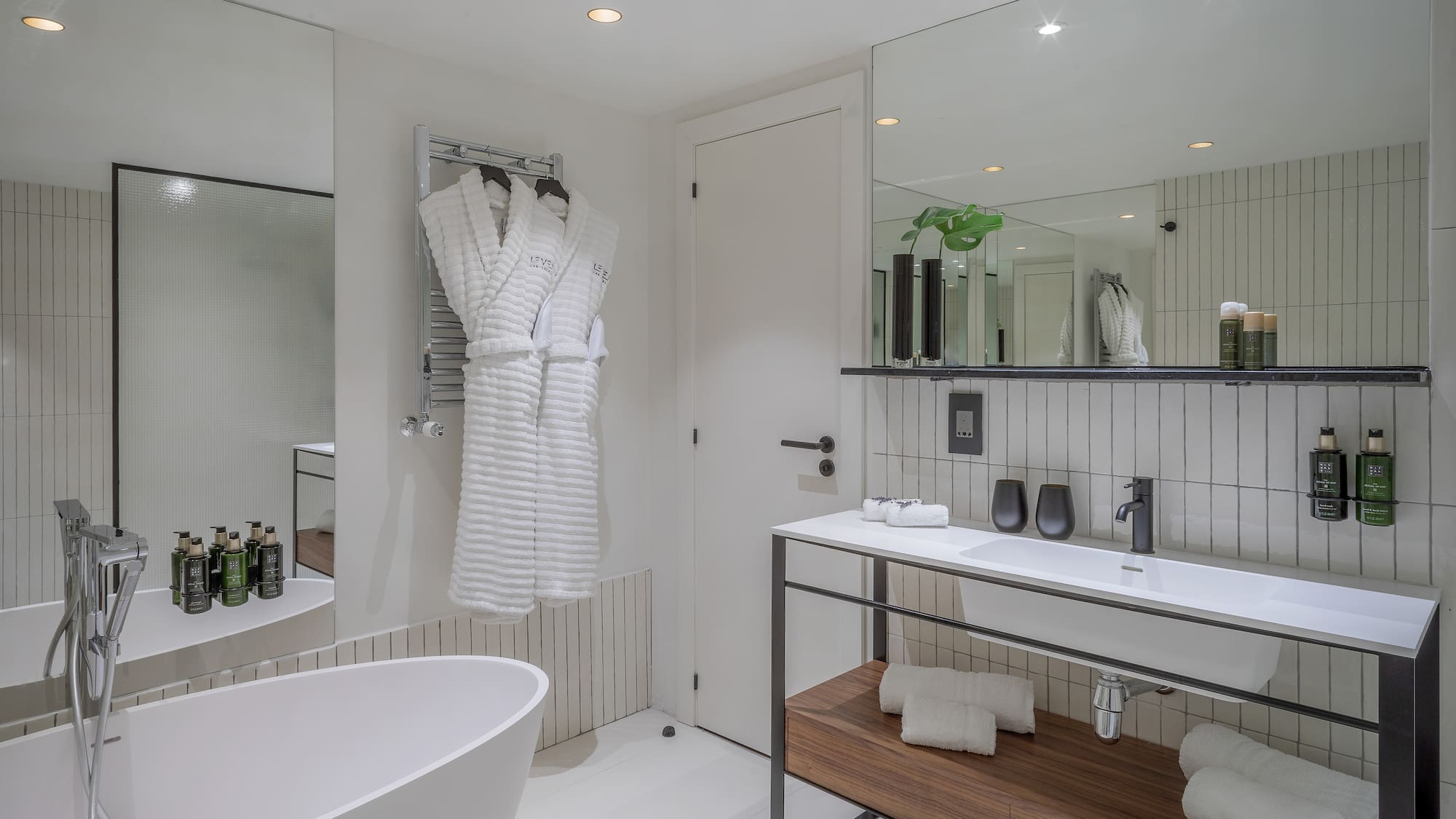 a bathroom with a bathrobe and a sink