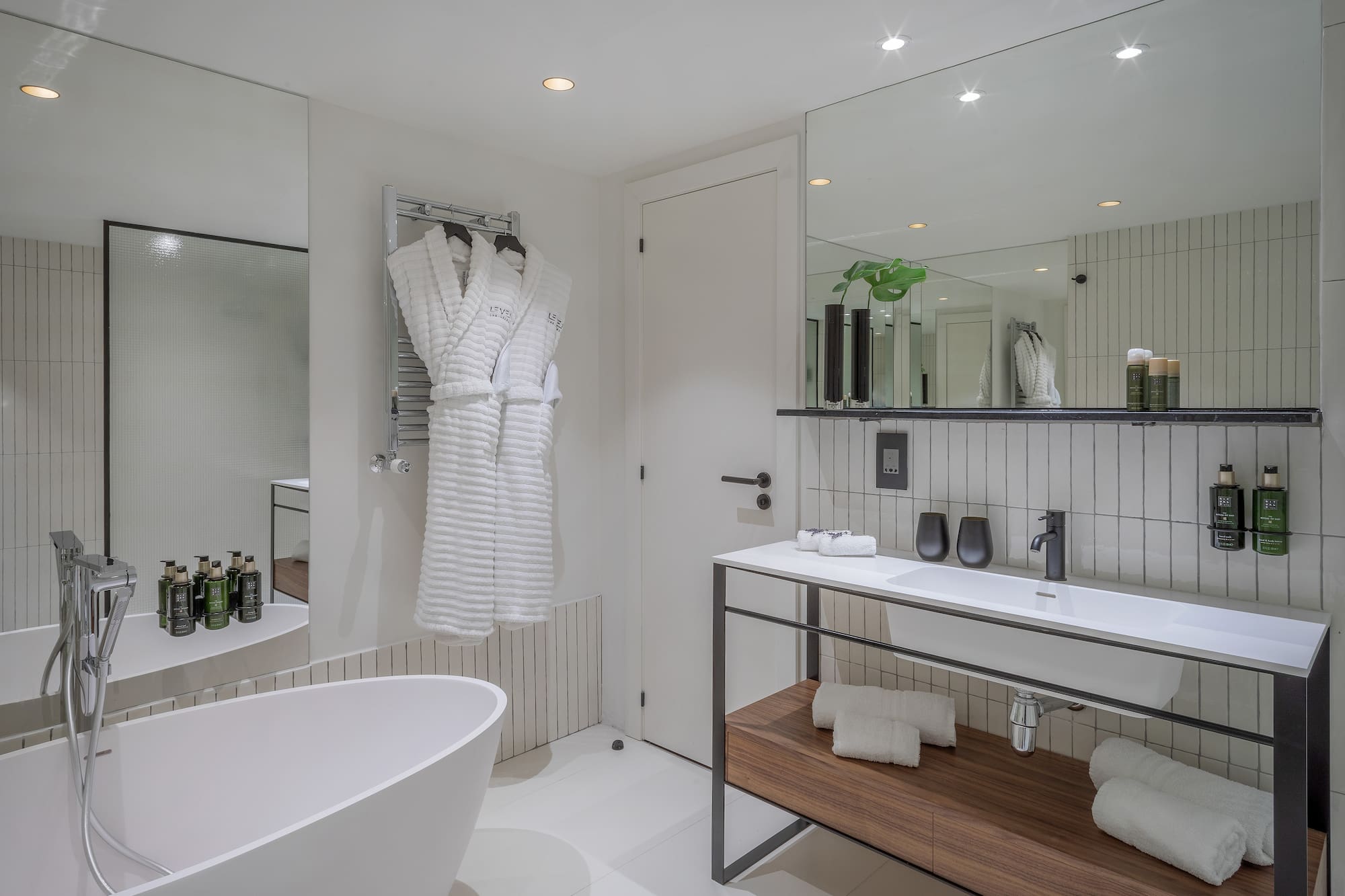 a bathroom with a bathrobe and a sink