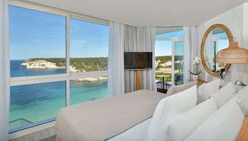 a room with a large window and a bed