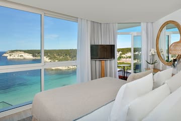 a room with a large window and a bed