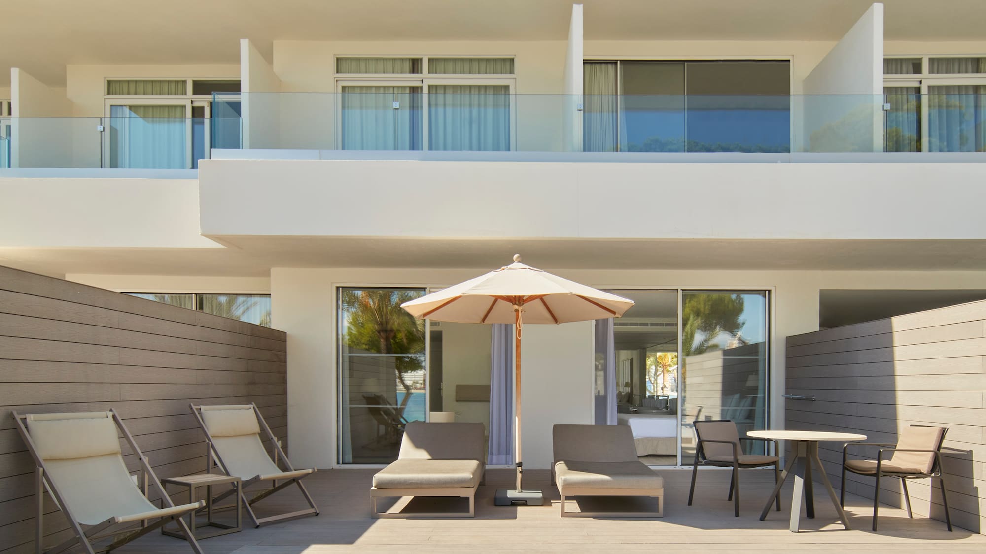 a patio with chairs and umbrella