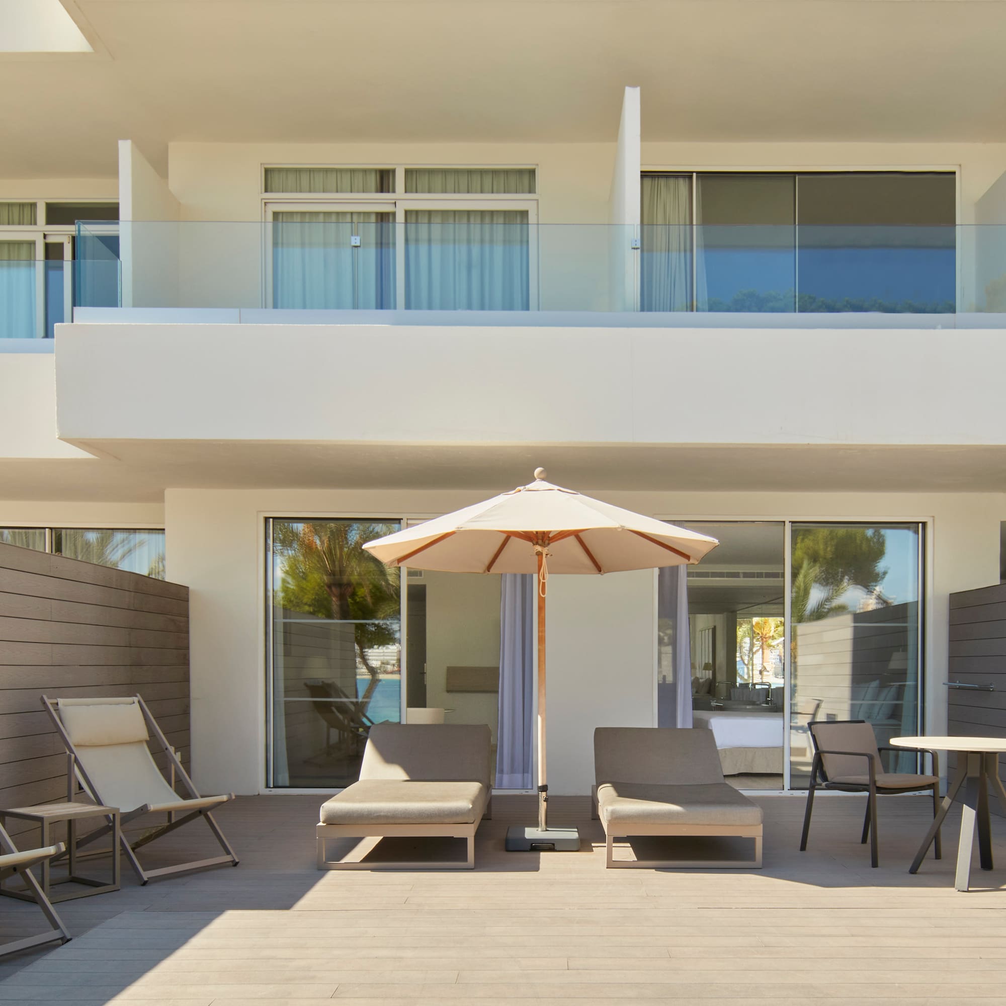 a patio with chairs and umbrella