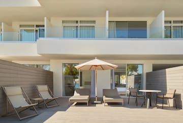 a patio with chairs and umbrella