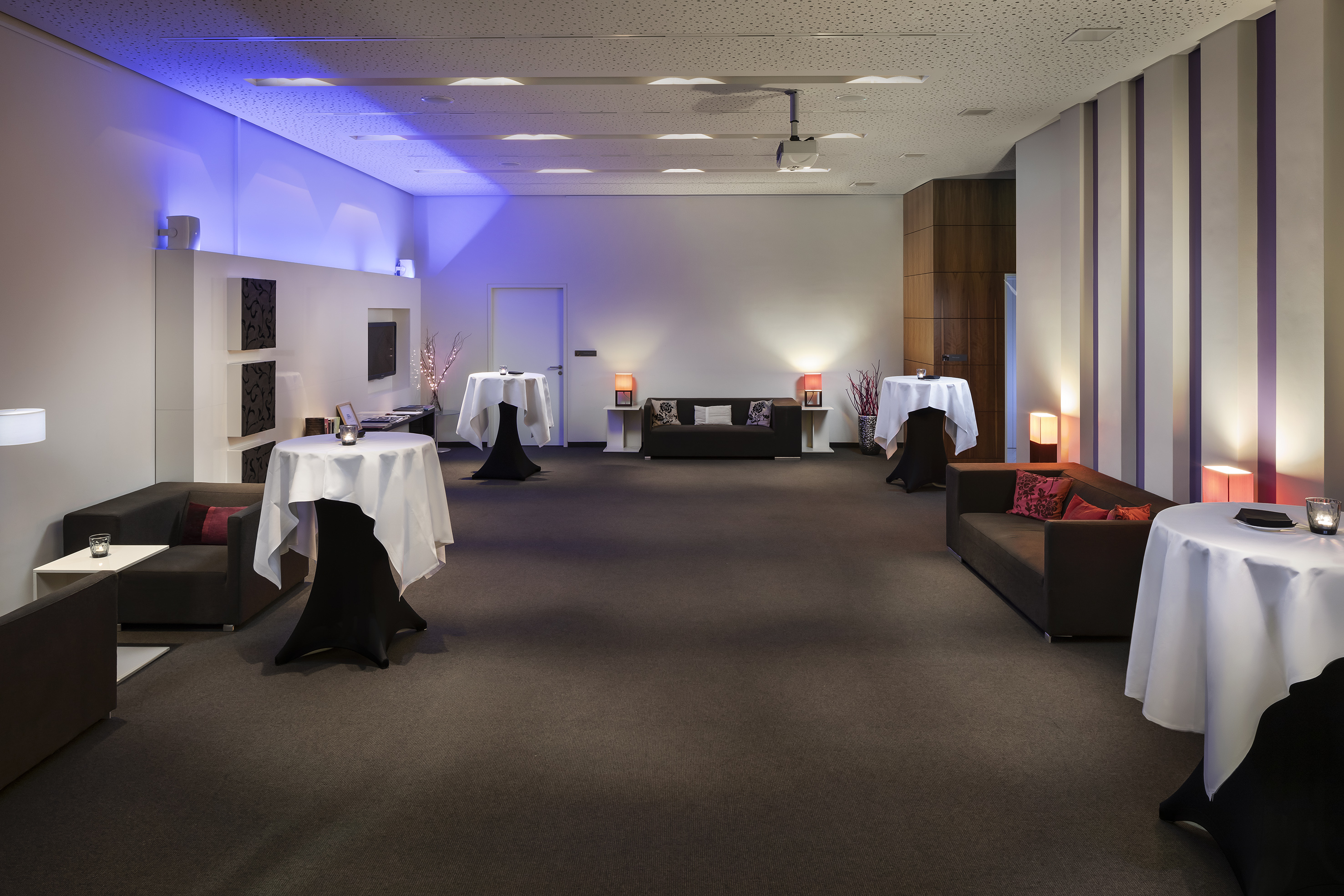 a room with tables and couches