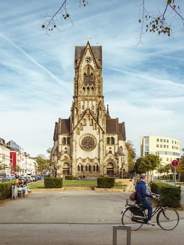 a person riding a bicycle in front of a church