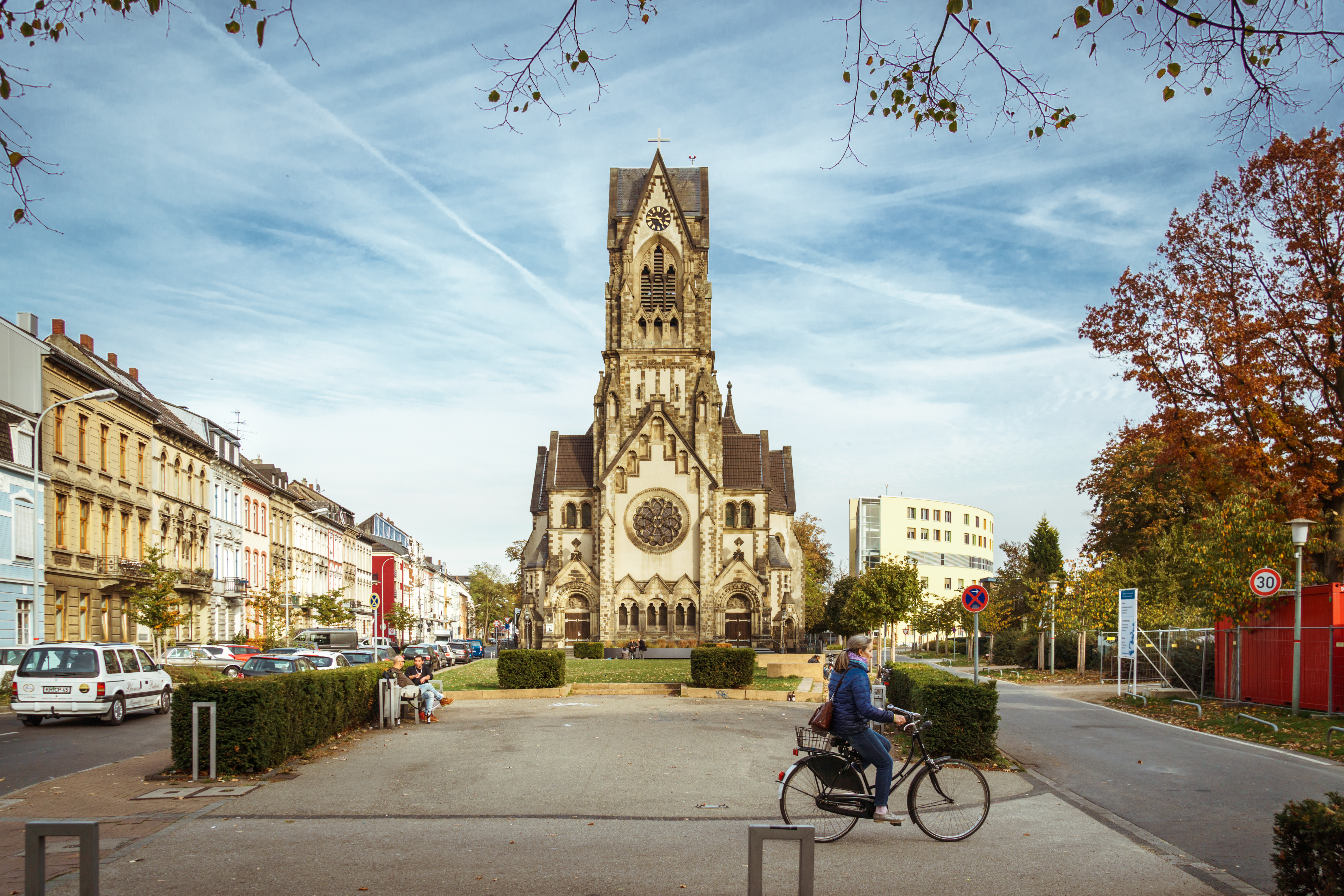 a person riding a bicycle in front of a church