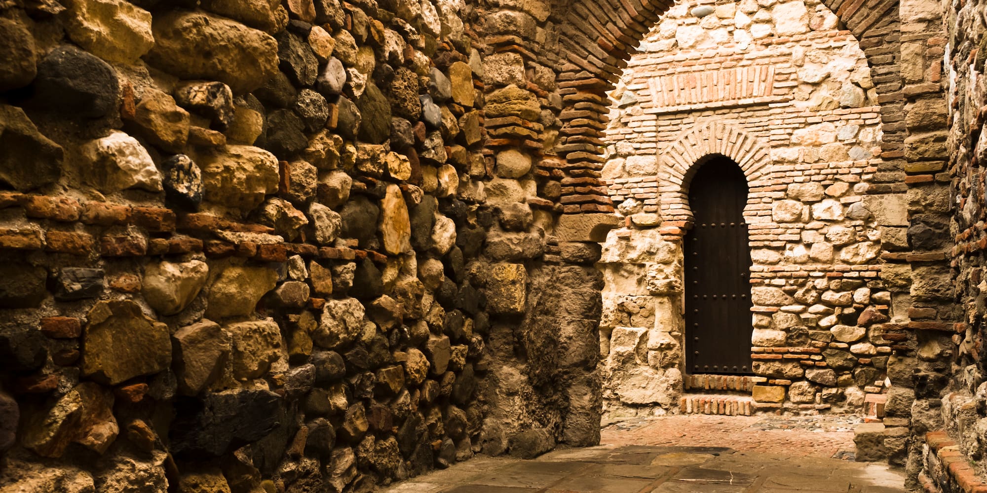 a stone archway with a door