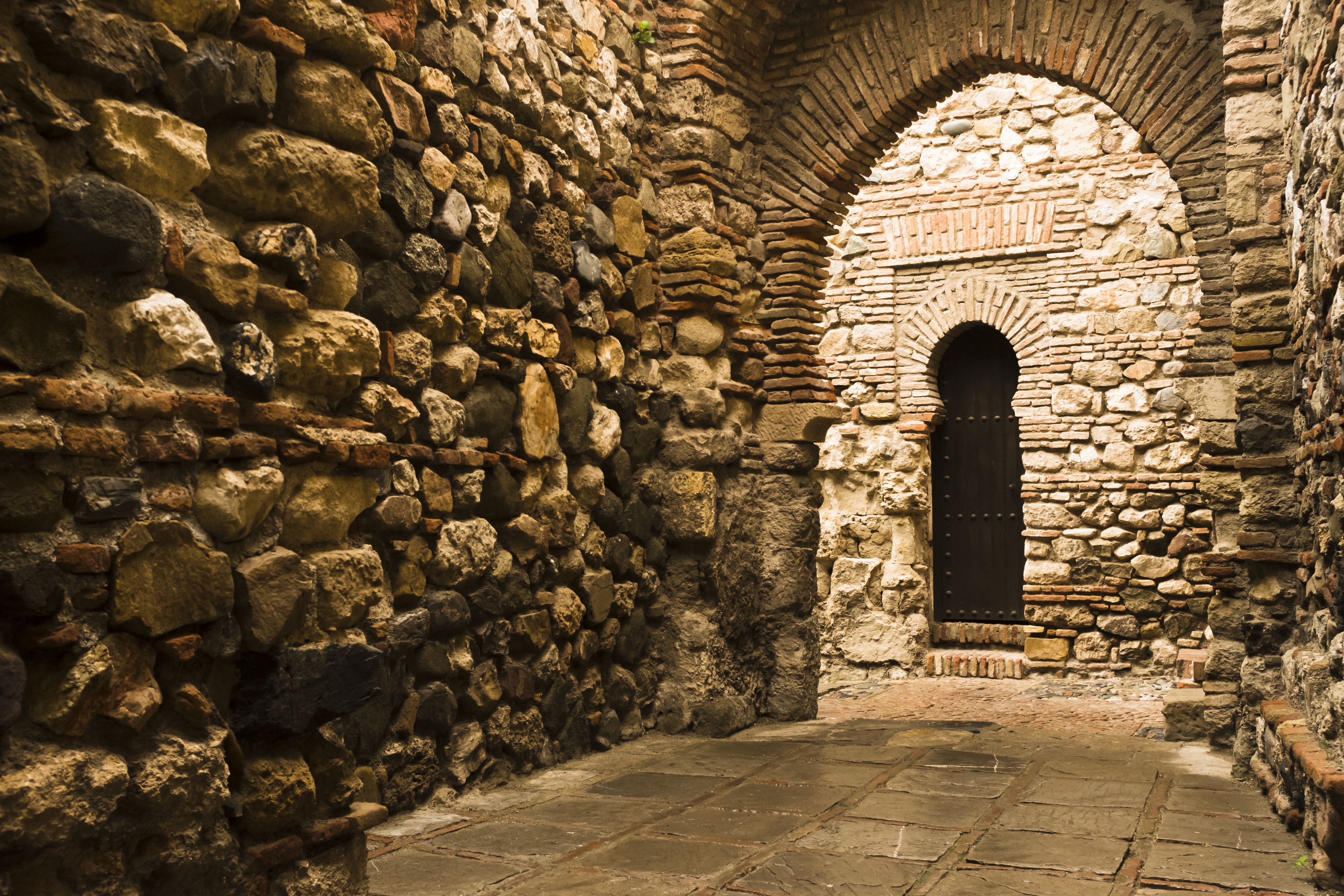 a stone archway with a door