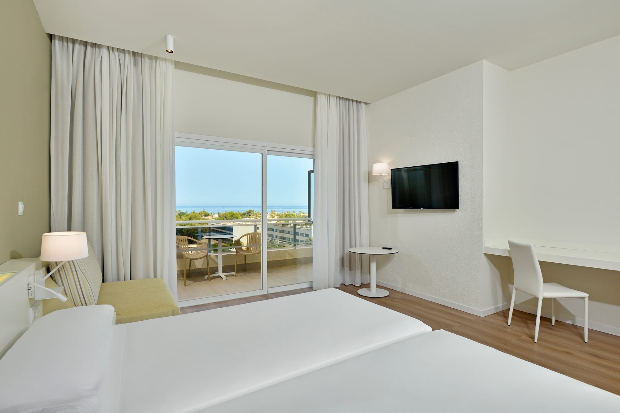 a room with a television and a balcony